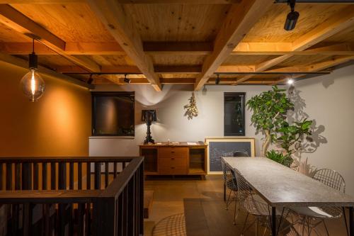a dining room with wooden ceilings and a table at HOTEL Sauna&Living in Iwanuma
