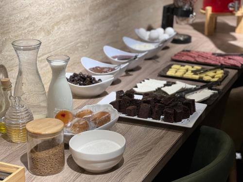 a table topped with plates of food on a table at Seagull Beachfront Boutique Hotel in Batumi