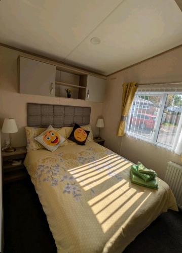 a bedroom with a large bed with a large window at St Marys Light house, Caravan Rentals in Whitley Bay