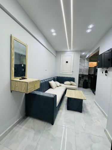 a living room with a couch and a table at The most wonderful view of Brital View North Coast in El Alamein
