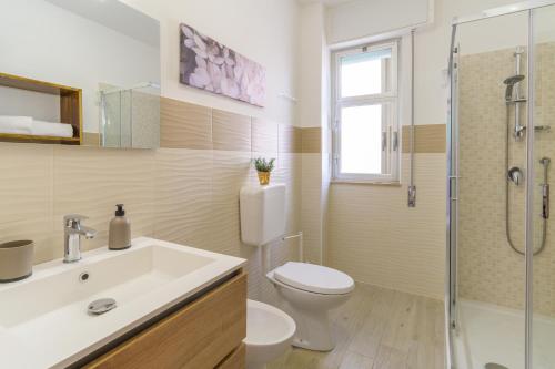 a bathroom with a toilet and a sink and a shower at siciliacasevacanze - Marina Domus 35 in Marina di Ragusa