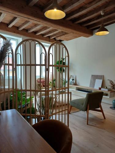 d'un salon avec une table et des chaises et d'une chambre avec une table. dans l'établissement L'Appartement Pasteur, à Chalon-sur-Saône