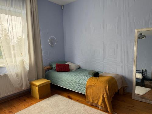 a small bed in a room with a window at Comfy stay at Hill of Clouds in Rāmava