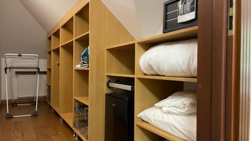 a room with wooden shelves with beds in it at Villa Romana Mazury in Jeziorowskie