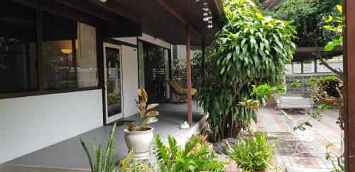 a porch of a house with plants on it at AT ASok Vintage House Near BTS Asok MRT Sukhumvit in Klong Toi