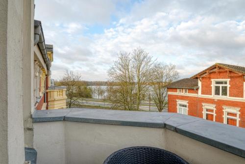 a view from the balcony of a building at Zuarin Seeblick - Ganzes Apartment direkt am Schlossgarten von Schwerin mit Dschungelfeeling in Schwerin