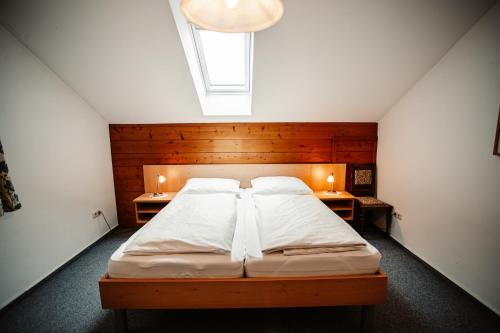 a bedroom with a large bed with two night stands at Annis Ausblick - Deine Unterkunft im Salzkammergut in Bad Goisern