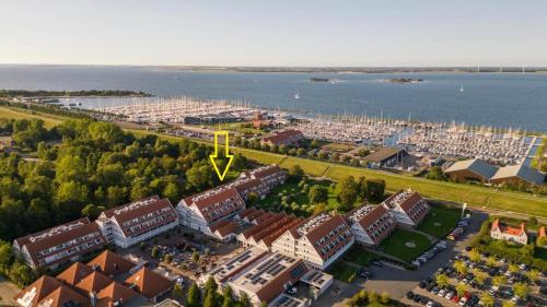 an aerial view of a city with buildings and the water at Zeeland cosy duplex appartment in Summio Parc Aquadelta resort in Bruinisse