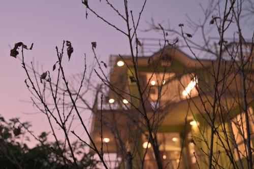 a blurry picture of a building with lights at Jaadooghar Rainbow Farms in Mussoorie