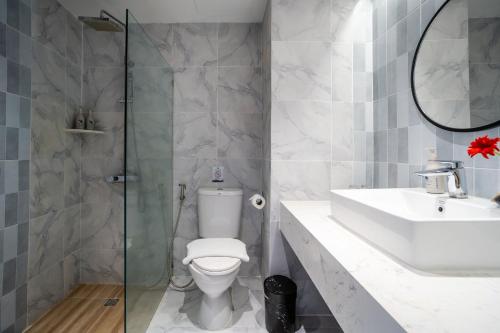 a bathroom with a toilet and a sink and a shower at Phuket Island View Resort - SHA Extra Plus in Karon Beach