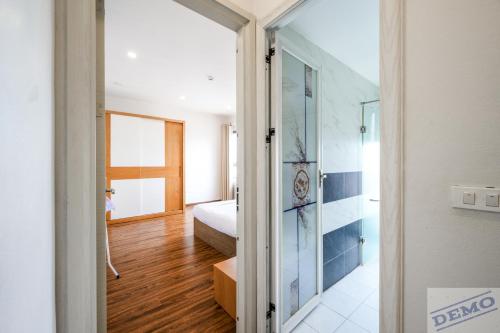 a room with a glass door leading to a bedroom at Paradise Hotel & Apartment Âu Cơ - Tay Ho Lake in Hanoi
