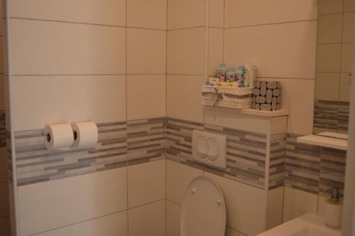 a bathroom with a toilet and two rolls of toilet paper at Apartments Lea in Hvar