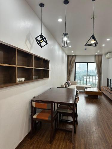 a dining room with a table and a couch at Paradise Hotel & Apartment Âu Cơ - Tay Ho Lake in Hanoi