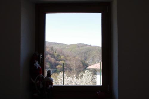 a window in a room with a view of a mountain at Casa vacanza Mariangela in Stregna