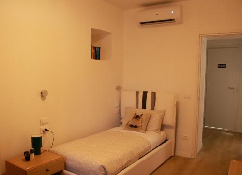 a bedroom with a bed with a dog pillow on it at Casa vacanza Mariangela in Stregna