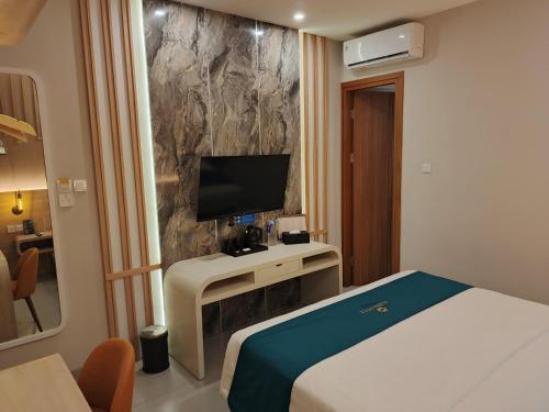 Ένα ή περισσότερα κρεβάτια σε δωμάτιο στο Azana Style Hotel Tulungagung