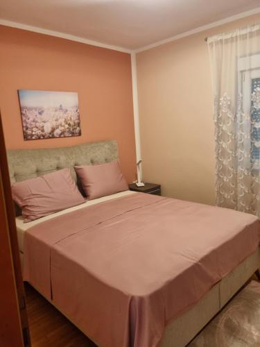a bedroom with a large bed and a window at Senkini Dvori in Sutomišćica