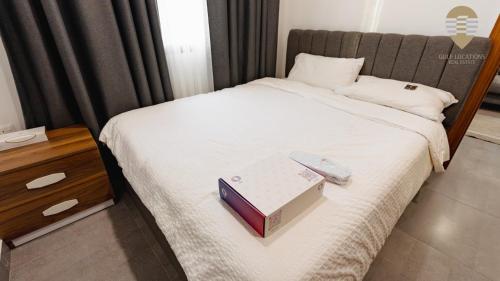 a bedroom with a bed with a book on it at Lavan One in Kuwait