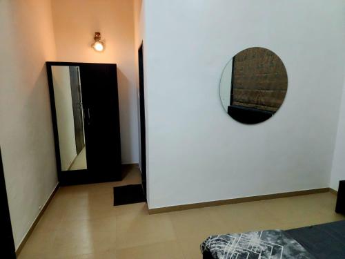 a room with a mirror on the wall and a door at Twilight Stays ll VILLA 9PM II SNOOKER TAB II SWIMMING POOL ll AC II BBQ in Lonavala