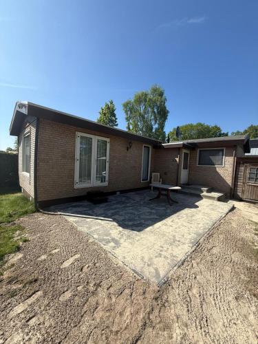 a house with a patio in front of it at Ruim Chalet Luxe 28 in Ledeacker