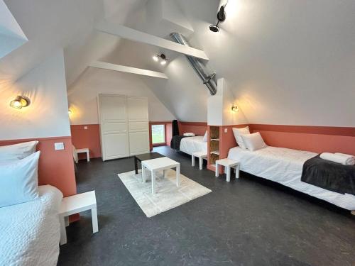 a room with two beds and a table in it at L'Escale Plouhatine family home 10 people in Plouha