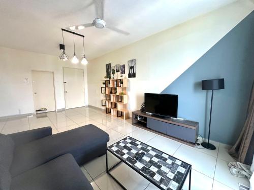 a living room with a couch and a tv at Saville Cheras 2 Bedroom HomeStay Link MRT in Cheras