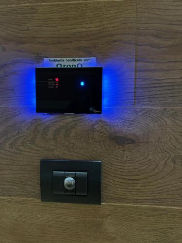 a electronic device on a wooden table with a blue light at Luna Residence Hotel in Casalmaggiore