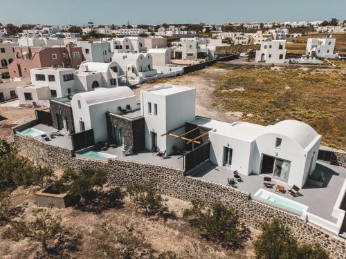 an aerial view of a city with white buildings at Uranides Luxury Suites in Santorini