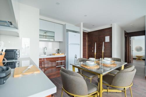 a kitchen and dining room with a table and chairs at Modern Furnished Apartments in Istanbul Basaksehir By Iradah Gayrimenkul in Basaksehir