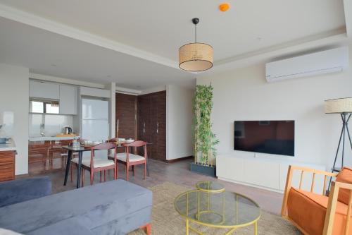 a living room with a couch and a table at Modern Furnished Apartments in Istanbul Basaksehir By Iradah Gayrimenkul in Basaksehir