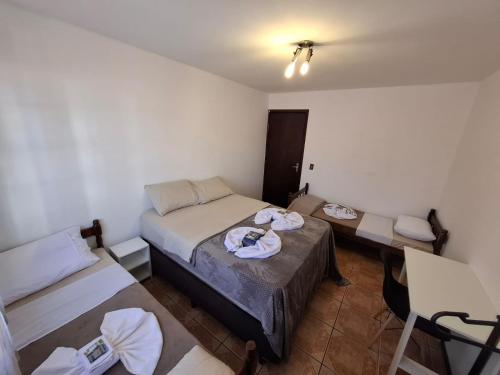 Ένα ή περισσότερα κρεβάτια σε δωμάτιο στο Ruta 40 Suites Quartos Estudos e AP