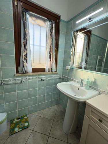 a bathroom with a sink and a mirror at B&B La Fenice Roma - Fiumicino in Rome