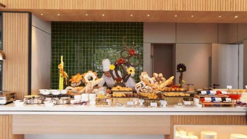 a buffet with a display of food on a table at A la Carte Ha Long Residences Căn hộ 5 stars cạnh biển in Ha Long