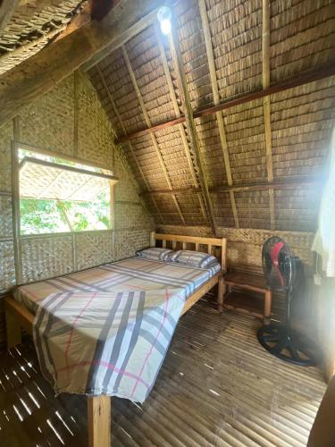 a bed in a room with a backpack on the floor at Jai Hidden Paradise in Romblon