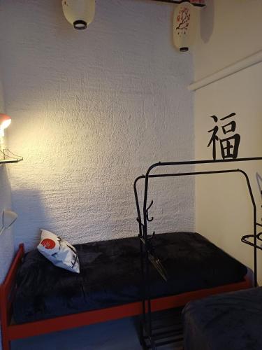 a room with a bed in a room with a lamp at Village Bord de Ciel in Caylus