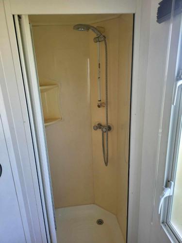a shower stall in a bathroom with a toilet at Living Holiday in Middelkerke