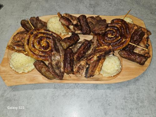 a plate of food with sausage and rice on a table at Wild A-frame in Baile Felix