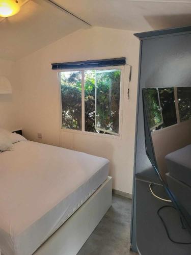 a small bedroom with a bed and a window at Living Holiday in Middelkerke