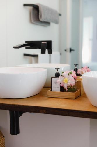 a bathroom counter with two white bowls and a sink at Dennarque Estate in Mount Wilson