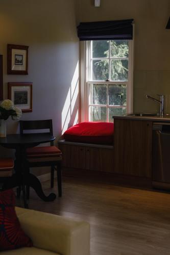 a bedroom with a red bed and a window at Dennarque Estate in Mount Wilson