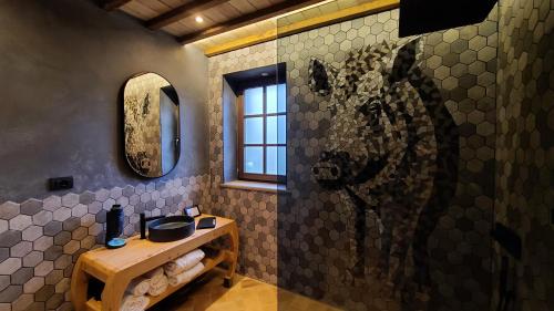 a bathroom with a horse painting on the wall at La Torre sulla via Francigena in Gambassi Terme