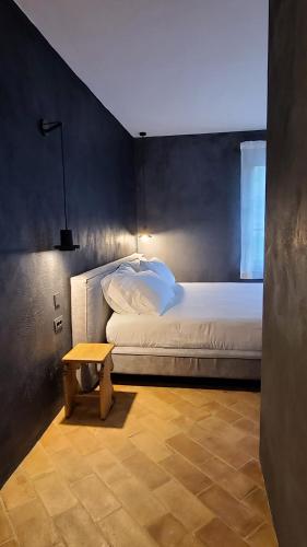 a bedroom with a bed with a bench and a window at La Torre sulla via Francigena in Gambassi Terme