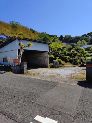 a building with a garage with a large door at itoshima 個性的な日本家屋 in Itoshima