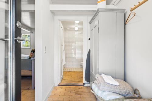 a room with a hallway with a bed and a bathroom at Solbjerggaard Bed & Breakfast in Fåborg