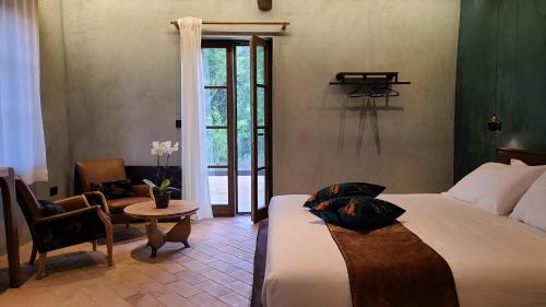 a bedroom with a bed and a table and a window at La Torre sulla via Francigena in Gambassi Terme
