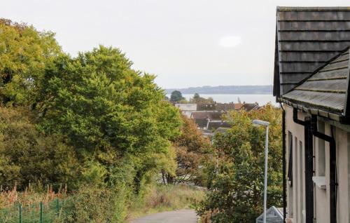 a house with a street light next to a road at City Line Apartment 5 in Carnmoney
