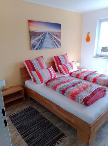 two beds in a bedroom with red pillows at Ferienwohnung Rackl in Furth im Wald