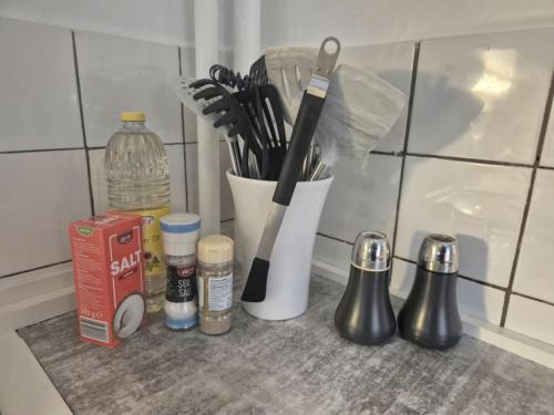 a kitchen counter with utensils and a container of utensils at Peaceful space in the midst of forest in Näsum