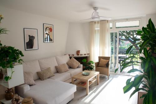a living room with a white couch and a table at Wonderful apartment in Gavà. Barcelona in Gavà
