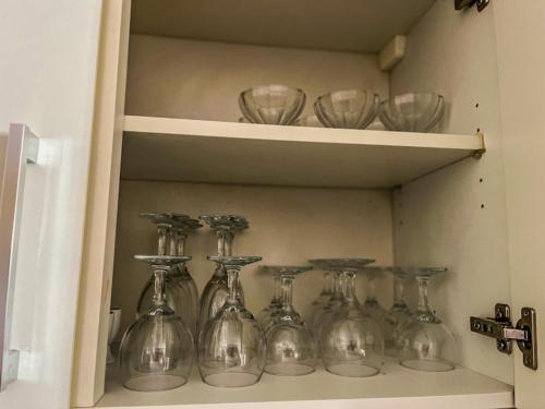 a row of glass vases sitting on a shelf at Iz-Ziffa Penthouse - Hosted by Encanto Gozo in Qala